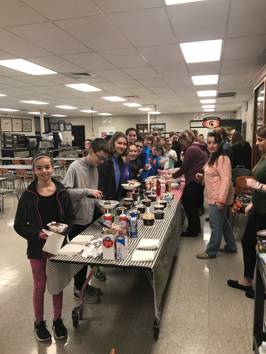 students standing around a table